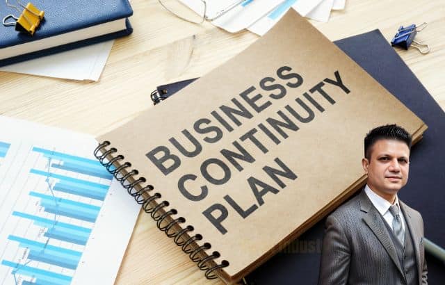 detailed business continuity plan document open on a desk.